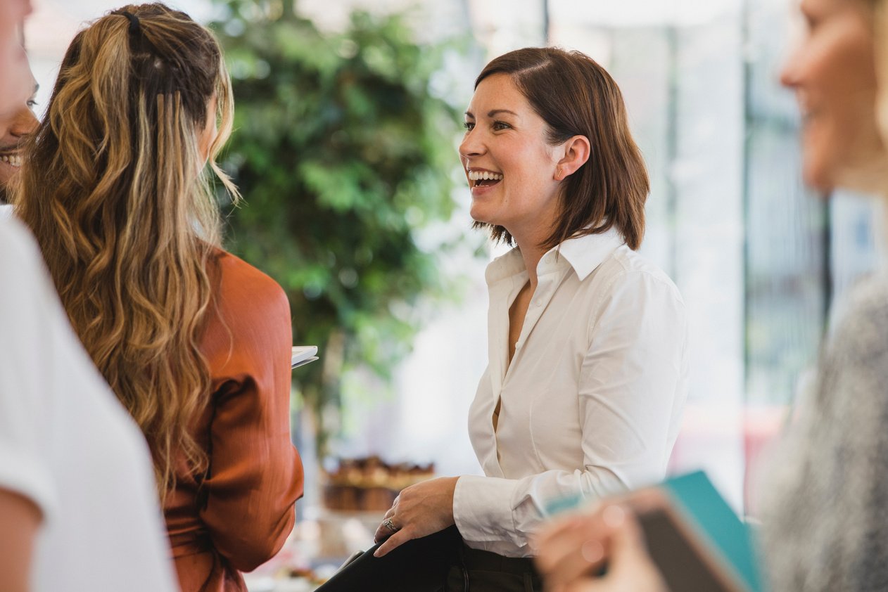 Cheerful colleagues laughing during corporate event